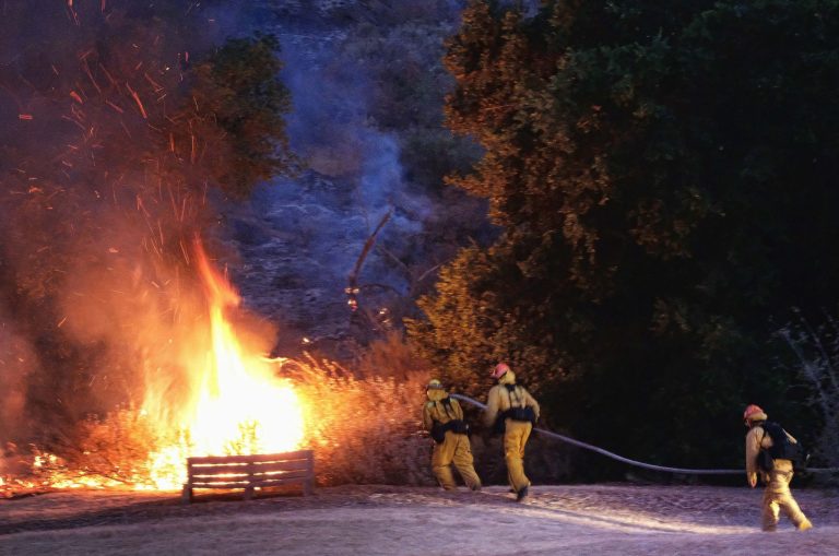 Firefighters approach a brush fire in the foothills outside of Calabasas, Calif., on June 4. (AP Photo/Richard Vogel)