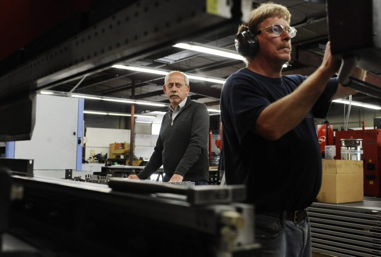Lou Tashash, owner and president of R-D Manufacturing Inc., left, watches break operator Scott Finlayson work at his precision sheet manufacturing business in East Lyme, Conn. Tashash, who employs 14 workers, is lobbying legislators to kill a measure to establish a state-run pension plan, which he sees as a burdensome mandate. Lawmakers in Connecticut and other states are responding to a widespread loss of private-sector pensions, a lack of access to employer-sponsored retirement accounts in smaller businesses and stagnant incomes that make it hard for workers to contribute to their own retirement plan or company account. (AP Photo/Jessica Hill)