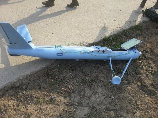 In this Monday, March 31, 2014 photo released by the South Korea Defense Ministry Wednesday, April 2, 2014, an unmanned drone lies on the ground damaged on Baengnyeong Island, South Korea, near the West Sea border with North Korea when the two Koreas fired hundreds of artillery shells into each other's waters. South Korea suspects that the drone that crashed on the frontline South Korean island was flown by rival North Korea, an official said Wednesday. (AP Photo/South Korea Defense Ministry)