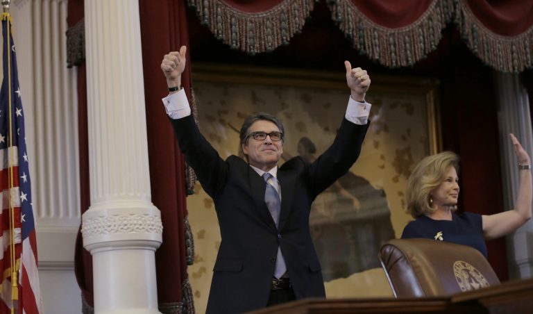 Texas Gov. Rick Perry, left, with his wife, Anita, right, acknowledges applause as he arrives to give a farewell speech to a joint session of the Texas Legislature, Thursday, Jan. 15, 2015, in Austin, Texas. (AP Photo/Eric Gay)