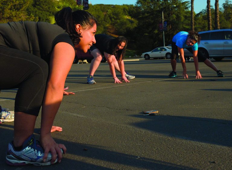 In this Tuesday, Dec. 11, 2012 photo, Zendi Solano, left, stretches with her running club in Pasadena, Calif. Dr. Robert Sallis says doctors with Kaiser Permanente, one of the nation's largest nonprofit health insurance plans, generally prescribe exercise first, instead of medication, and for many patients who follow through, that's often all it takes. (AP Photo/Mark J. Terrill)