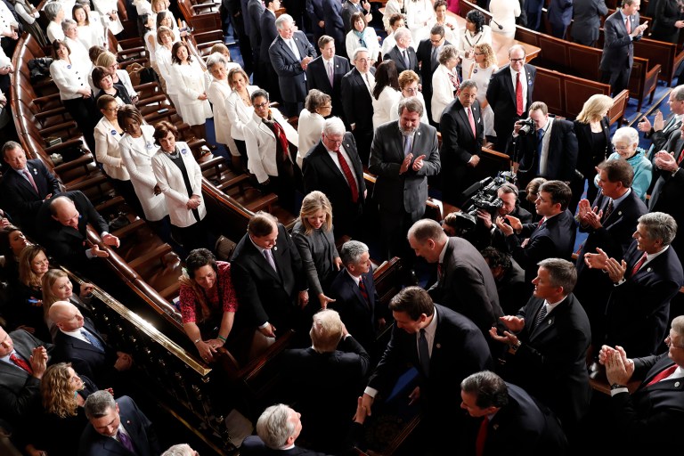 Women Democratic member of Congress, wearing white in honor of women's suffrage, watch as President Trump arrives to address a joint session of Congress. (AP Photo/Pablo Martinez Monsivais)