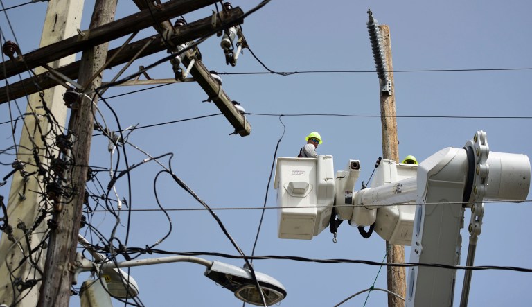 A brigade from the Puerto Rico Electric Power Authority repairs distribution lines damaged by Hurricane Maria. Puerto Rico's government scored a big win in court Monday after a judge rejected the appointment of a former military officer to oversee the U.S. territory's troubled power company. (AP Photo/Carlos Giusti, File)