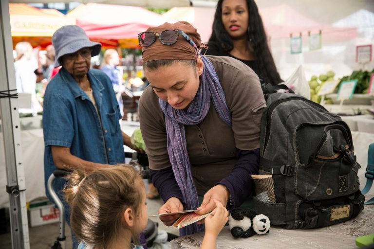 A woman and her daughter counts out Electronic Benefits Transfer (EBT) coupons, more commonly known as Food Stamps, while shoping for groceries in the GrowNYC Greenmarket in Union Square on September 18, 2013 in New York City. (Photo by Andrew Burton/Getty Images)