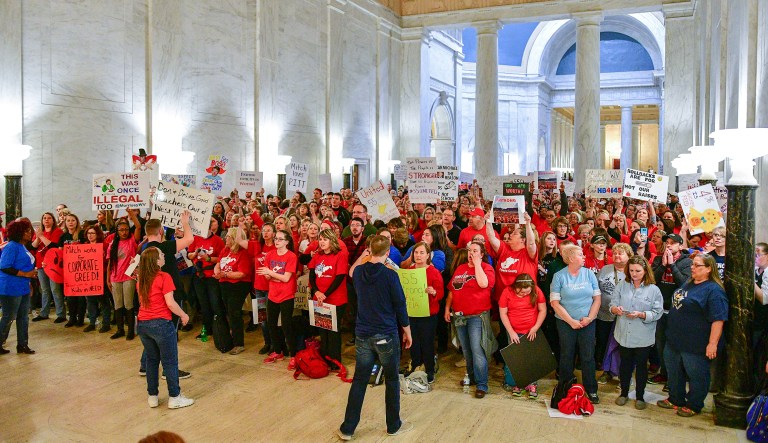 In this photo from Monday, teachers hold a rally outside the Senate Chambers in the West Virginia Capitol in Charleston, W.Va. Hundreds of teachers from 55 counties are on strike for pay raises and better health benefits. (AP Photo/Tyler Evert)