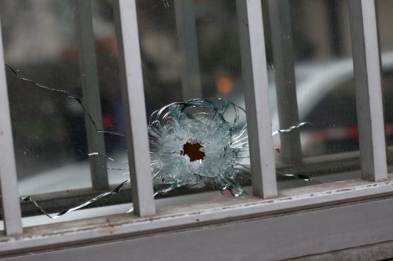 A bullet impact is seen in a window of a building next to the French satirical newspaper Charlie Hebdo's office, in Paris. (AP/Thibault Camus)