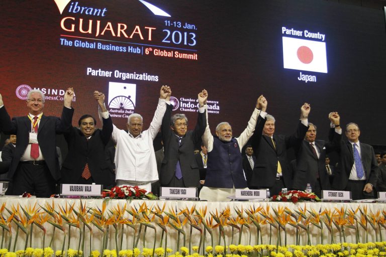 FILE - In this Jan. 11, 2013 file photograph, Gujarat Chief Minister Narendra Modi, fourth right, poses with business leaders and other delegates during the inauguration of 6th Vibrant Gujarat Global Summit (VGGS) in Gandhinagar, India. To some, the man in pole position to be Indiaâs next prime minister is a visionary reformer, while to others heâs an autocrat in bed with big business cronies. Perhaps nowhere are opinions of Narendra Modi more polarized than in Gujarat, the western state led by him for more than a decade and now touted as a model of prosperity for the rest of India to emulate.(AP Photo/Ajit Solanki, file)