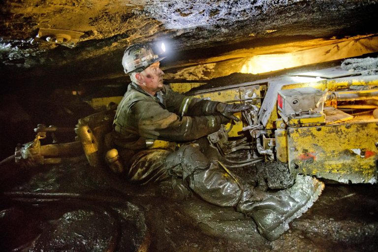 Scott Tiller, a coal miner of 31 years, operates a continuous miner machine in a coal mine roughly 40-inches-high in Welch, W.Va. Most of the job losses happened long before coal's latest downturn. Mechanization began slashing the number of workers needed to mine coal in the 1960s, and then a collapse in the U.S. steel industry in 1980s further decimated miners' ranks. (AP Photo/David Goldman)