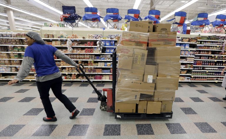In this June 17, 2014 photo, a stocker rolls product to restock at a Kroger grocery store in Richardson, Texas. The Commerce Department releases wholesale trade inventories for June on Friday, Aug. 8, 2014. (AP Photo/LM Otero)