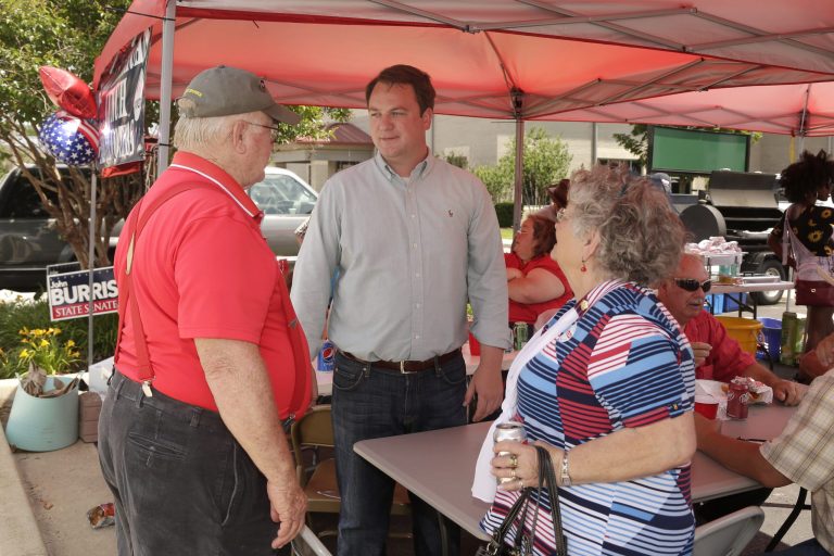 State Rep. John Burris, center, campaigns for a state Senate seat in Harrison, Ark. A GOP runoff for a north Arkansas state Senate seat has turned into a proxy fight over the state's nationally-heralded program backed by Burris to use federal Medicaid funds to purchase private insurance for the poor. (AP Photo/Danny Johnston)