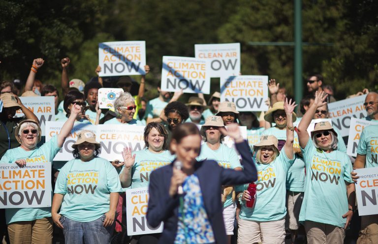 Clean air advocates cheer as Mary Anne Hitt, director of the Sierra Club's Beyond Coal Campaign, speaks at a rally outside an Environmental Protection Agency hearing, Tuesday, July 29, 2014, in Atlanta. Utility and coal companies are expected to argue Tuesday against proposals from the Obama administration that would force a 30 percent cut in carbon dioxide emissions by the year 2030 from 2005 levels. The EPA is holding three public hearings on the proposal in Atlanta, Denver and Washington. (AP Photo/David Goldman)