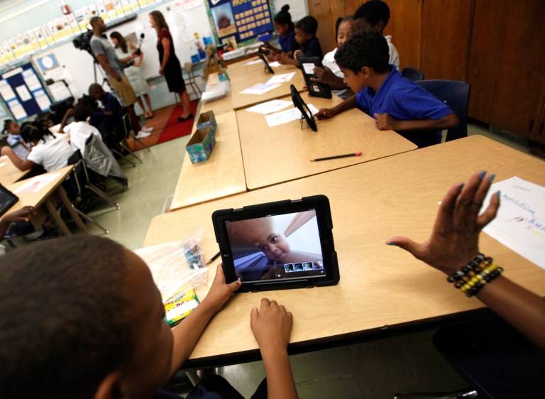 FILE - In this Aug. 27, 2013, file photo, Muhammad Nassar Jr. takes a picture of himself using an i-pad during Karen Finkel's class at Broadcrest Elementary School in Carson, Calif.  Faced with criticism about the planning and rollout of a $1 billion effort by the Los Angeles Unified School District to provide iPads to all students, Superintendent John Deasy has suspended future use of a contract with Apple Inc. (AP Photo/Los Angeles Times, Bob Chamberlin, File) NO FORNS; NO SALES; MAGS OUT; ORANGE COUNTY REGISTER OUT; LOS ANGELES DAILY NEWS OUT;  INLAND VALLEY DAILY BULLETIN OUT; MANDATORY CREDIT, TV OUT