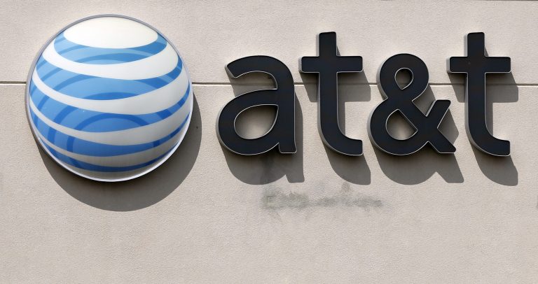This Wednesday, May 14, 2014 photo shows the company logo at an AT&T store in Dedham, Mass. AT&T reports quarterly financial results on Wednesday, July 23, 2014. (AP Photo/Steven Senne)