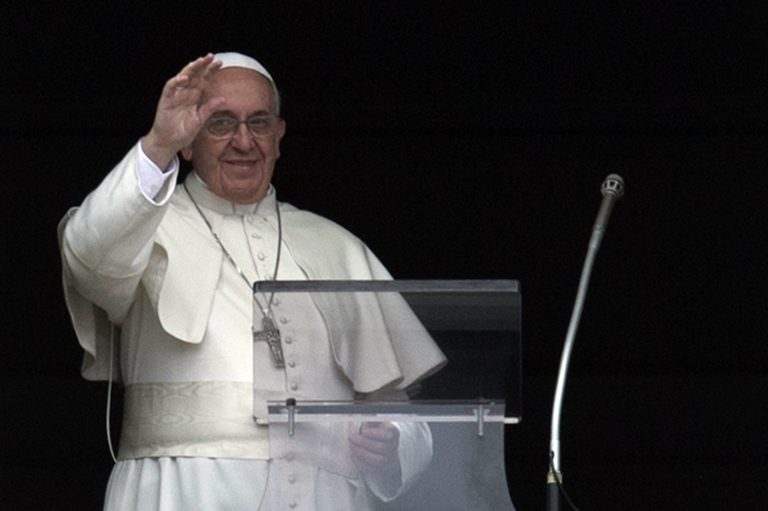 Pope Francis delivers his blessing during the Angelus noon prayer he celebrated from the window of his studio overlooking St. Peter's Square, at the Vatican,  Sunday, March 23, 2014. (AP Photo/Andrew Medichini)