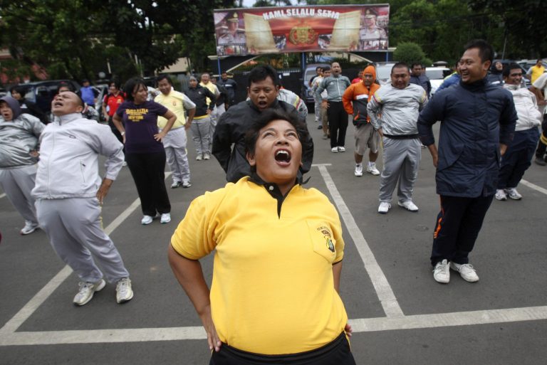   In this photo taken Dec. 4, 2012, plain-clothes Indonesian police officers do exercise during a new diet program for police in Tangerang, outskirts of Jakarta, Indonesia. Anyone over 100 kilograms (220 pounds) must follow the weight-loss program started because of the growing number of overweight officers and the perception that they are unable to provide public protection, said a Jakarta police spokesman. (AP Photo/Tatan Syuflana)  