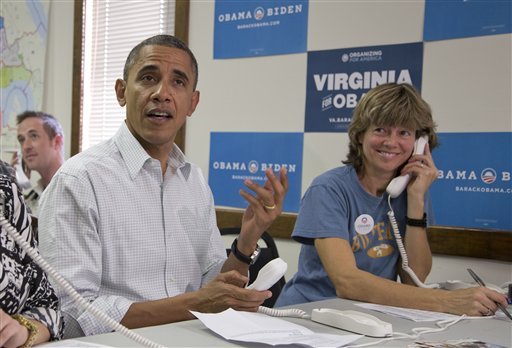 President Barack Obama makes phone calls to volunteers at an Organizing for America field office with Suzanne Stern, right,  Sunday, Oct. 14, 2012, in Williamsburg, Va. (AP Photo/Carolyn Kaster)
