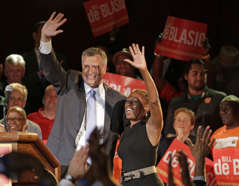 New York City Democratic Mayoral hopeful Bill De Blasio celebrates on stage with his wife Chirlane, right, after addressing supporters at his election headquarters after polls closed in the city's primary election Wednesday, Sept. 11, in New York. (AP/Kathy Willens)