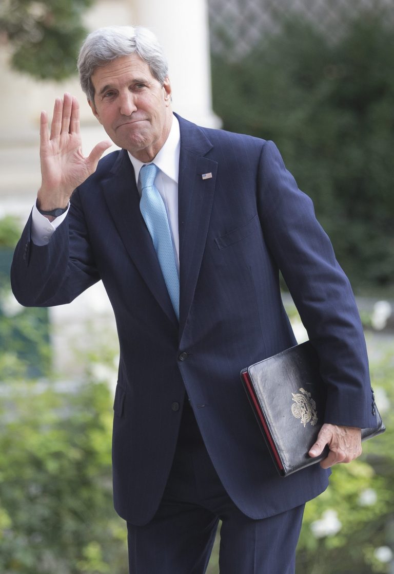 U.S. Secretary of State John Kerry waves to the media as he arrives at the U.S. embassy for a meeting with the Arab League in Paris, Monday, Oct. 21, 2013. Kerry is in Paris for diplomatic talks about a peace process for Israel and Palestinian authorities. (AP Photo/Michel Euler)
