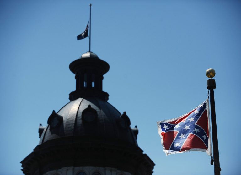 The Confederate flag flies near the South Carolina Statehouse, Friday, June 19, 2015, in Columbia, S.C. Tensions over the Confederate flag flying in the shadow of South Carolina's Capitol rose this week in the wake of the killings of nine people at a black church in Charleston, S.C. (AP Photo/Rainier Ehrhardt)