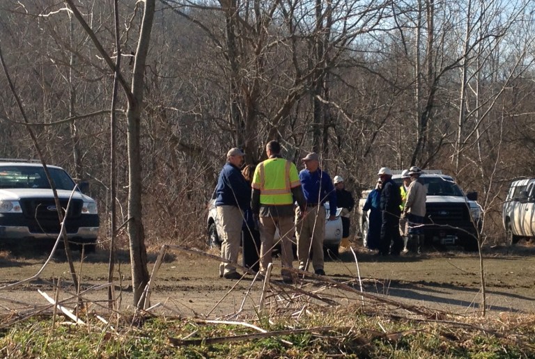 Officials prepare clean-up materials at the scene of a leak from a crude oil pipeline on Tuesday, March 18, 2014, in Colerain Township, Ohio. A Colerain Township fire official said the leak has been contained and that there is no immediate danger to the public. Capt. Steve Conn told The Cincinnati Enquirer oil leaked into a creek and collected in a marshy wetland, and it wasn't clear whether it reached ponds and the Great Miami River. (AP Photo/The Cincinnati Enquirer, Gary Landers)  MANDATORY CREDIT;  NO SALES