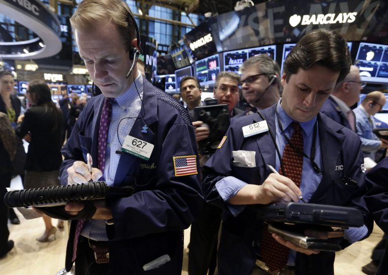 FILE - In this Friday, Jan. 17, 2014, file photo, traders Michael Smyth, left, and Patrick McKeon, work on the floor of the New York Stock Exchange. (AP Photo/Richard Drew, File)