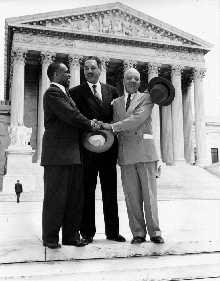 FILE - This May 17, 1954 file photo shows, from left, George E.C. Hayes, Thurgood Marshall, and James M. Nabrit joining hands as they pose outside the Supreme Court in Washington.  The three lawyers led the fight for abolition of segregation in public schools before the Supreme Court, which ruled today that segregation is unconstitutional. On May 17, 1954, a hushed crowd of spectators packed the Supreme Court, awaiting word on Brown v. Board of Education, a combination of five lawsuits brought by the NAACP's legal arm to challenge racial segregation in public schools. The high court decided unanimously that 