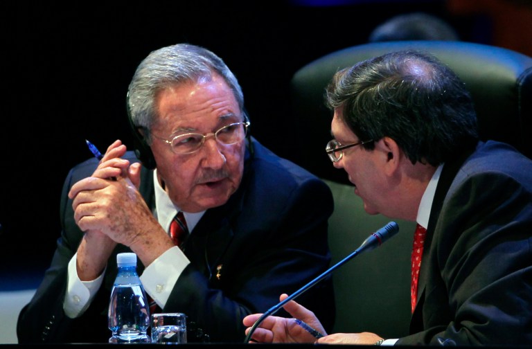 Cuba's President Raul Castro speaks to his Foreign Minister Bruno Rodriguez during a session of the CELAC Summit in Havana, Cuba, Tuesday, Jan. 28, 2014. Leaders from Latin America and the Caribbean are in Cuba to talk about poverty, inequality and hunger at the summit of the Community of Latin American and Caribbean States, or CELAC. (AP Photo/Cubadebate, Ismael Francisco)
