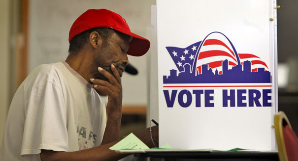 A man votes at a polling place.