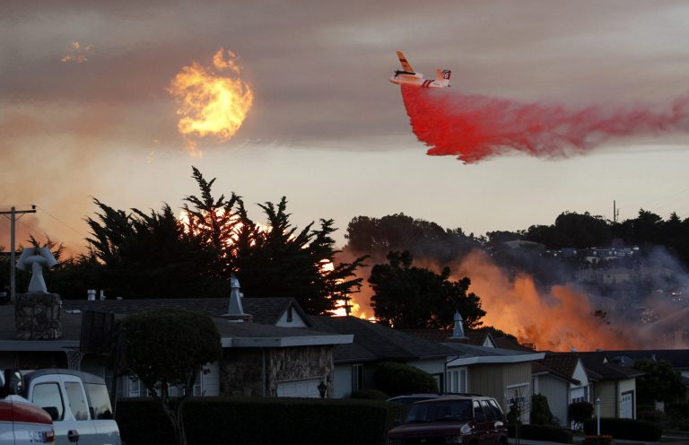 FILE - In this Sept. 9, 2010, file photo, a massive fire following a pipeline explosion roars through a mostly residential neighborhood in San Bruno, Calif. A proposed utility fine that would create a nearly $1 billion windfall for the state of California has set up a regulatory tussle over how the state punishes corporate wrongdoing and who should benefit from the record-sized penalty. (AP Photo/Jeff Chiu, File)