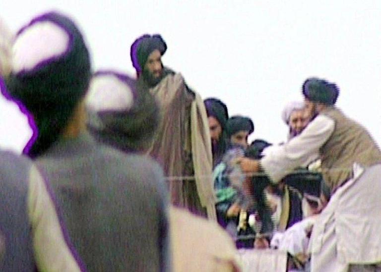 This is an image made from video that was taken by the BBC2 current affairs program Newsnight five years ago, that Newsnight claims to be of Mullah Mohammed Omar, center, the leader of Afghanistan's ruling Taliban movement. The footage, that lay undiscovered in the BBC's vaults until the Newsnight program shown, late Wednesday, Sept. 19, 2001, was taken as Omar rallied his troops in the Afghan city of Kandahar. (AP Photo/BBC TV - Newsnight)