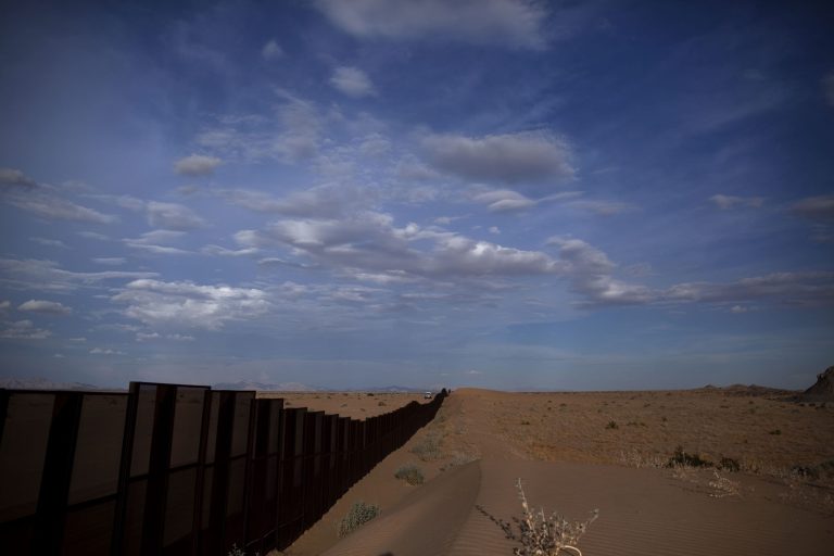A U.S. border patrol vehicle drives along the U.S.-Mexico border fence on the outskirts of San Luis Rio Colorado, Mexico, in July 2010. (AP Photo/Guillermo Arias)