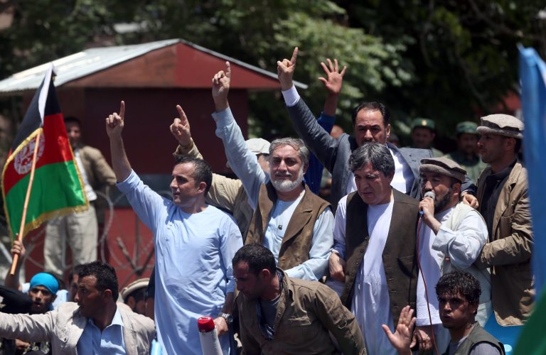 Afghanistan's presidential candidate Abdullah Abdullah, center, waves to his supporters during a protest against election fraud in Kabul, Afghanistan, Friday, June 27, 2014. Afghanistan's security situation has been complicated by a political crisis stemming from allegations of massive fraud in the recent election to replace President Hamid Karzai, the only leader the country has known since the Taliban regime was ousted nearly 13 years ago. Abdullah Abdullah, one of two candidates who competed a runoff vote on June 14 suspended his relations with the Independent Election Commission after he accused electoral officials of engineering extensive vote rigging, allegations they have denied. (AP Photo/Massoud Hossaini)