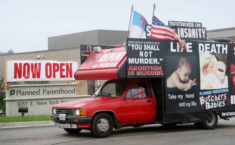 A truck covered with anti-abortion messages near a Planned Parenthood clinic. (Scott Olson/Getty Images)
