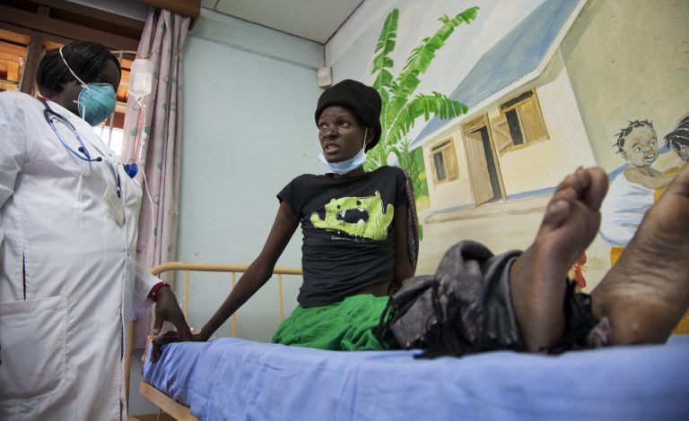 A newly-diagnosed HIV positive woman, who arrived at the hospital with symptoms of tuberculosis (TB), receives treatment at the Mildmay Uganda clinic, which receives funding from the US government through the Centers for Disease Control and Prevention (CDC), in Kampala, Uganda Thursday, Feb. 27, 2014. Uganda's government has been hit with substantial aid cuts after the president enacted a severe anti-gay measure over which some Western governments had warned of consequences, and at least three European countries are withdrawing millions in direct support to Uganda's government, which depends on donors for about 20 percent of its budget. (AP Photo/Rebecca Vassie)