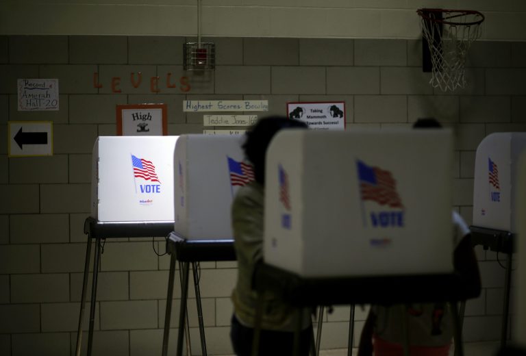 Sunlight shines through a window onto a voting booth at a polling place inside Winfield Elementary School in Windsor Mill, Md. (AP Photo/Patrick Semansky)