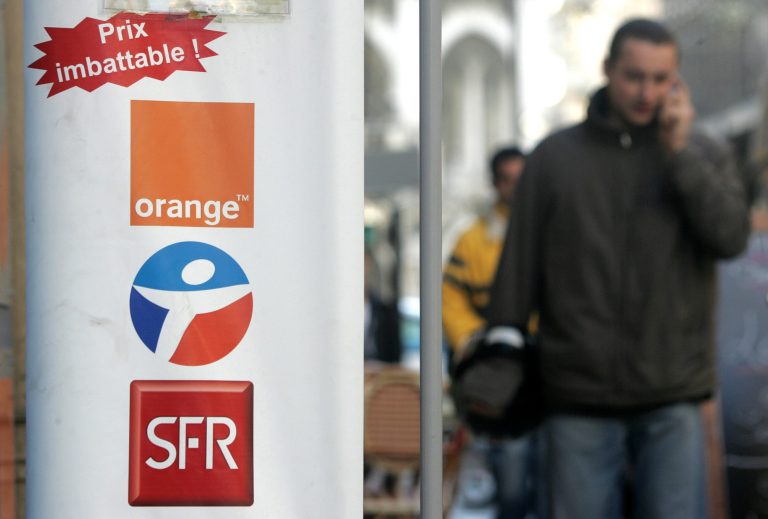 FILE - This Dec. 1, 2005, file photo shows three logos of French mobile operators : SFR, Bouygues and Orange, displayed at the entrance of a telephone store in Nice, southern France. French conglomerate Bouygues is offering euro10.5 billion  ($14.4 billion) for control of mobile operator SFR telecommunications, entering a bidding war for the Vivendi unit. Bouygues said Thursday its offer to combine SFR with Bouygues Telecom would create a new number one mobile operator in France, leapfrogging current market leader Orange. (AP Photo/Lionel Cironneau, File)