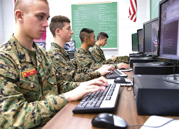 The Marine Military Academy CyberPatriot team practices their security skills before the competition this week in Harlingen, Texas. (AP Photo/Valley Morning Star, David Pike)