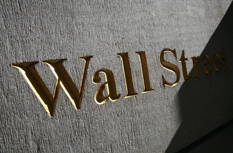 FILE - In this March 8, 2010, file photograph, a sign for Wall Street is shown near the New York Stock Exchange. World stock markets mostly declined Monday, June 16, 2014, as the turmoil in Iraq dampened sentiment and investors held back ahead of the Federal Reserve's monthly policy meeting later in the week. (AP Photo/Mark Lennihan, File)