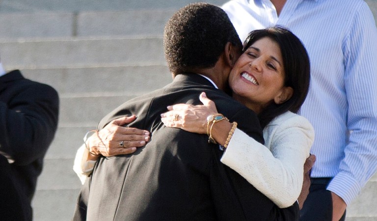 South Carolina Gov. Nikki Haley hugs Rev. Norvel Goff, interim pastor at Emanuel AME Church in Charleston, before an honor guard from the South Carolina Highway Patrol removed the Confederate battle flag from the Capitol grounds, Friday, July 10, 2015, in Columbia, S.C. (AP Photo/John Bazemore)