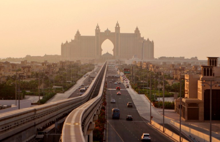 FILE - This Wednesday, Sept. 8, 2010 file photo shows an avenue leading to the Atlantis hotel on the Palm Jumeirah Island in Dubai, United Arab Emirates. A Dubai government conglomerate behind some of the emirate's industrial powerhouses said Thursday, April 3, 2014, it has bought a 