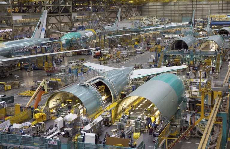 Employees work on the Boeing 777 assembly line June 13, 2012 at the Boeing Factory in Everett, Washington. (Photo by Stephen Brashear/Getty Images)