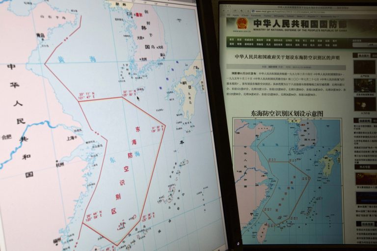 Computer screens display a map showing the outline of China's new air defense zone in the East China on the website of the Chinese Ministry of Defense, in Beijing Tuesday, Nov. 26, 2013. Beijing on Saturday, Nov. 23, 2013 issued a map of the zone - which includes a cluster of islands controlled by Japan but also claimed by China - and a set of rules that say all aircraft entering the area must notify Chinese authorities and are subject to emergency military measures if they do not identify themselves or obey Beijing's orders. Chinese characters in red in the center of the map at left reads: 