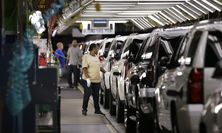 An auto worker inspects finished SUVs coming off the assembly line at a General Motors auto plant in Arlington, Texas. The manufacturer warned Friday that it may lose its competitive edge worldwide under the Trump administration's proposed automotive tariffs.