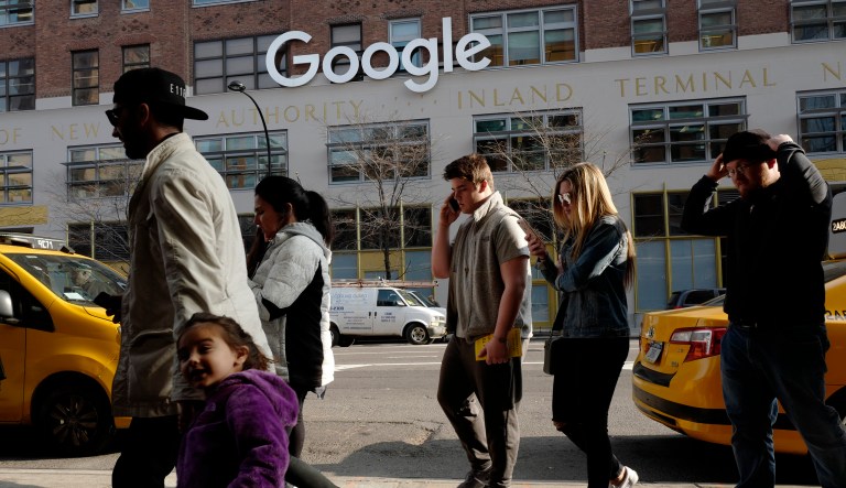 People walk by Google offices in New York in December 2017. 