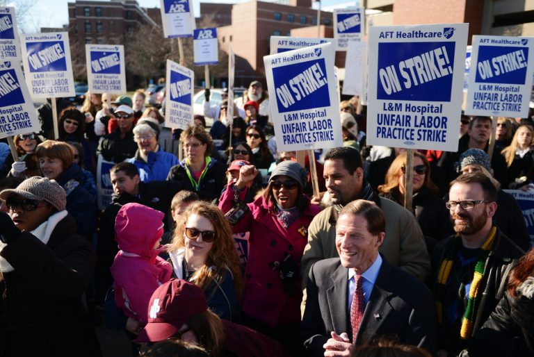 New London Mayor Daryl Finizio, right, and U.S. Sen. Richard Blumenthal, D-Conn., second right, join striking nurses and medical technicians and supporters from labor unions for a rally in front of Lawrence and Memorial Hospital in New London on Nov. 29. (AP/The Day, Sean D. Elliot)