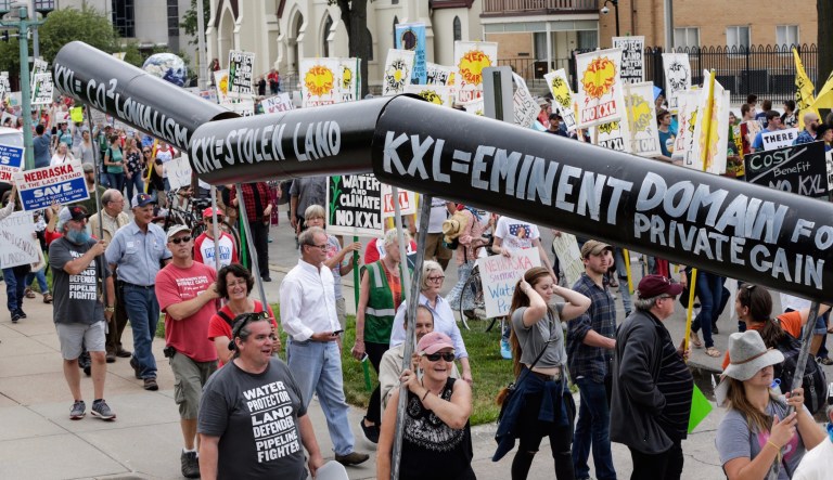 Demonstrators against the Keystone XL pipeline marched in Lincoln, Neb. on Aug. 6, one day before the Nebraska Public Service Commission began a five-day public hearing to decide whether to approve the Keystone XL pipeline's route through the state. (AP Photo/Nati Harnik)