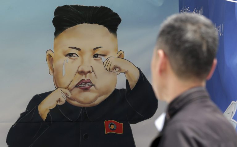 A man looks at a caricature of crying North Korean leader Kim Jong-Un hanging at a participant's booth during the Unification Expo in downtown Seoul, South Korea, Friday, May 29, 2015. (AP Photo)Â 