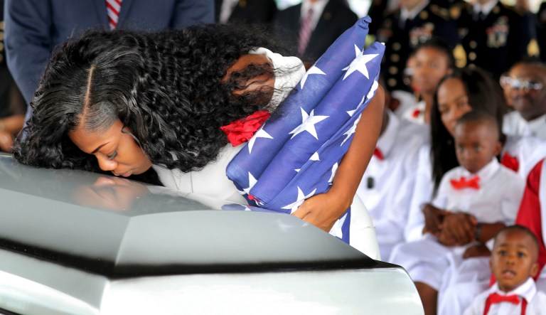Myeshia Johnson, the wife of Army Sgt. La David Johnson, kisses her husband's casket during his funeral service in Hollywood, Fla. Sgt. Johnson was killed with three other colleagues in an ambush by extremists in Niger. (Mike Stocker/South Florida Sun-Sentinel via AP)