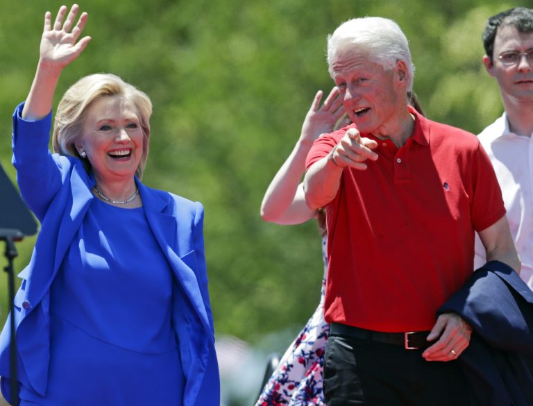 Democratic presidential candidate, former Secretary of State Hillary Rodham Clinton, and former President Bill Clinton, right gesture to supporters Saturday, June 13, 2015, on Roosevelt Island in New York. (AP Photo/Frank Franklin II)
