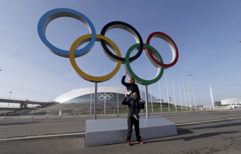 Visitors pose in front of the Olympic rings at the 2014 Winter Olympics Saturday, Jan. 25, 2014, in Sochi, Russia. The Olympics begin Feb. 7th. (AP Photo/David J. Phillip)